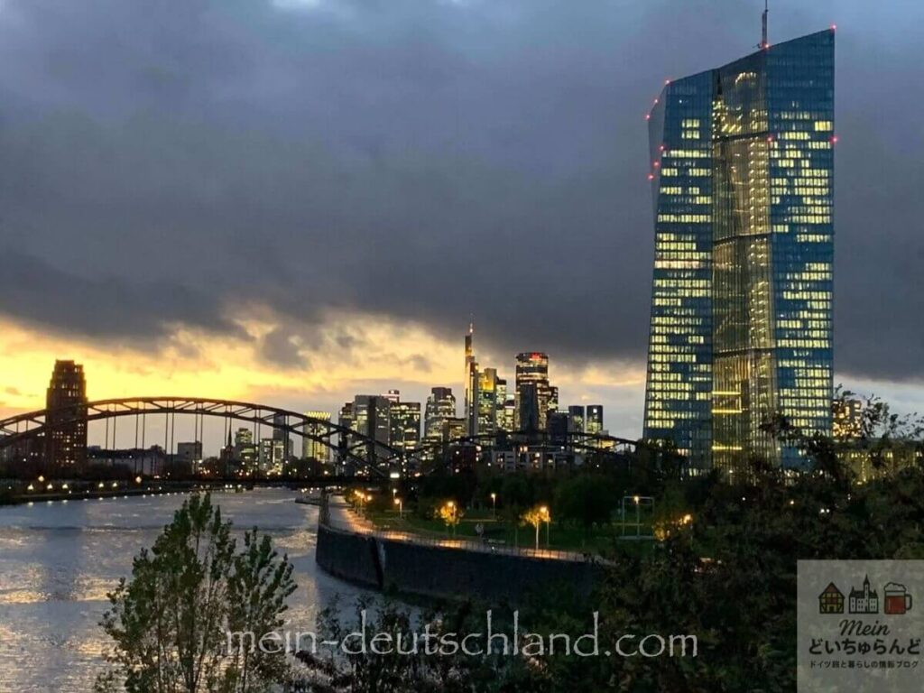 フランクフルトの夕暮れに輝く高層ビル群とマイン川の風景